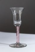 AN 18TH CENTURY RED AND WHITE TWIST WINE GLASS with inverted bell bowl. 16cms high.