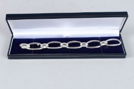 A HEAVY SILVER OPEN LINK BRACELET.