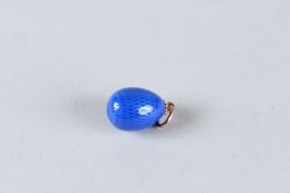 A 14CT GOLD BLUE ENAMEL EGG PENDANT.