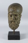 A MID 19TH CENTURY BRONZE GREEK BUST OF A MAN. 8ins, on a wooden base.