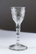 AN 18TH CENTURY WINE GLASS with engraved bowl and facet stem. 15cms high.