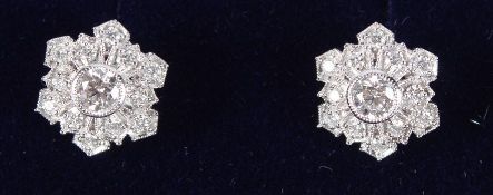 A PAIR OF PLATINUM SNOWFLAKE DIAMOND CLUSTER EARRINGS.