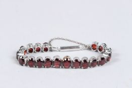 A SILVER AND GARNET BRACELET.