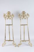 A LARGE PAIR OF BRASS PICTURE EASELS. 2ft 8ins long.