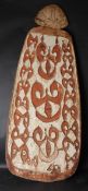 AN ASMAT SHIELD from PAPUA NEW GUINEA, carved as a figure of a man. 195cms high.