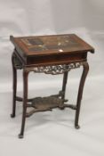 A FRENCH LACQUER CHINESE DESIGN WORK TABLE, the rising top with Chinese figures, on a stand with
