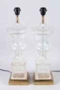 A PAIR OF BRASS AND GLASS URN SHAPED LAMPS on wooden bases, with glass shades. 2ft 10ins high.