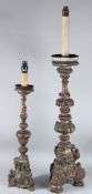 TWO ITALIAN CARVED WOOD AND GILDED CANDLESTICKS. 80cms and 50cms high.