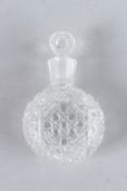 A SMALL CUT GLASS SCENT BOTTLE AND STOPPER. 8cms high.