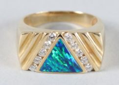 A 14CT GOLD, OPAL AND DIAMOND MEN'S RING.