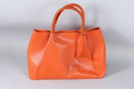 A MIU MIU ORANGE LEATHER BAG. 36cms high.