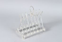 A SILVER PLATED CROSS GOLF CLUB TOAST RACK.
