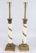 A PAIR OF CORINTHIAN COLUMN LAMPS on brass stepped bases. 22ins high.