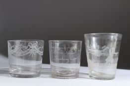 AN 18TH CENTURY TUMBLER engraved with a deer hunting scene, 10cms high, and two others (3).