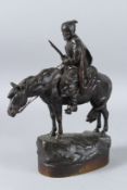 A. M. BONEGOR (RUSSIAN). A BRONZE MAN carrying a sun, sitting on a horse. Signed. 28cms high.