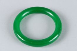 A LARGE APPLE GREEN BANGLE. 8cms diameter.