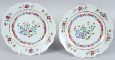 A SUPERB PAIR OF CHINESE FAMILLE ROSE PLATES. 9ins diameter. Painted with a European holding a bird.