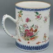 A CHINESE TANKARD with panels of flowers. 4.5ins high. Circa 1740.