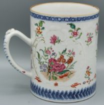 A CHINESE TANKARD with panels of flowers. 4.5ins high. Circa 1740.