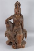 A LARGE CHINESE CARVED WOOD FIGURE OF GUANYIN, also known as GUAN-YIN OR KUAN-YIN, sitting in a