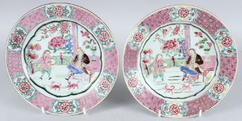 A FINE PAIR OF CHINESE EXPORT PORCELAIN PLATES painted in pink with a Mandarin, a young boy and