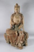 A LARGE CHINESE CARVED AND PAINTED WOODEN FIGURE OF GUANYIN seated in a posture known as 