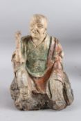 A CARVED WOOD AND POLYCHROME STATUE OF A SEATED MONK OF ARHAT. 30cms high.