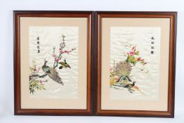 A GOOD PAIR OF CHINESE SILKWORK PICTURES of peacocks and flowers, framed and glazed. 50cms x 34cms.