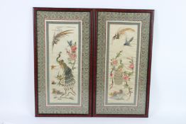 A GOOD PAIR OF CHINESE SILKWORK PICTURES of peacocks and flowers, framed and glazed. 64cms x 32cms.