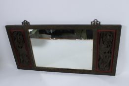 A CHINESE WOODEN FRAMED MIRROR. 84cms x 42cms.