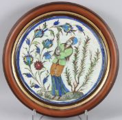 A GOOD PERSIAN QAJAR 19TH CENTURY CERAMIC PLAQUE, a man holding a guitar surrounded by flowers.
