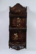 A JAPANESE LACQUER SET OF SHELVES with figures and motifs. 100cms x 36cms.