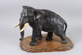 A LARGE JAPANESE BRONZE ELEPHANT. 19th Century on a wooden base. SUBMISSION REFERENCE:D26BFS53