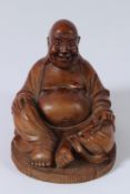 A CARVED WOOD LAUGHING BUDDHA. 16cms high.