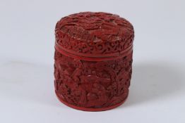 A CHINESE CINNABAR LACQUER CIRCULAR BOX AND COVER. 9cms high.
