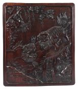 A GOOD CHINESE CARVED WOOD PANEL depicting Lions. 45cms x 40cms.