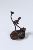 A JAPANESE BRONZE OKIMONO BIRD AND LOTUS. 8cms high.