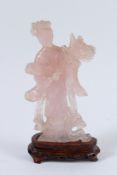 A CHINESE ROSE QUARTZ OF GUANYIN on a wooden base. 18cms high.