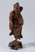 A CHINESE CARVED WOOD FIGURE OF A FISHERMAN. 36cms high.