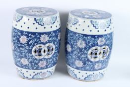 A PAIR OF CHINESE BLUE AND WHITE BARREL SEATS. 42cms high.