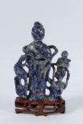 A GOOD CHINESE CARVING OF A DEITY and figure made of Lapis Lazuli. 20cms high.