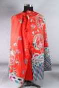 A CHINESE RED GROUND EMBROIDERED ROBE.