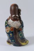 A JAPANESE POTTERY FIGURE OF FUKUROKUJU, one of the seven gods of fortune. 28cms high.