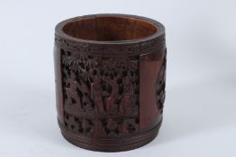 A CHINESE CARVED BAMBOO BRUSH POT, also known as a BITONG. 12cms high.