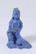 A CHINESE BLUE GLAZED CERAMIC FIGURE OF A DEITY GUANYIN. 15cms high.