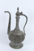 A PERSIAN METAL EWER. 42cms high.