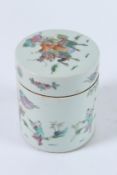 A CHINESE FAMILLE ROSE POT AND COVER with figures and flowers. 12cms high.