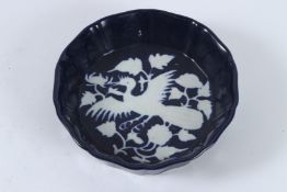 A SACRIFICE BLUE GROUND GLAZE WHITE PHOENIX BOWL. 17cms diameter.