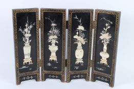 A SMALL LACQUER AND MOTHER-OF-PEARL FOUR-FOLD FOLDING SCREEN. 36cms high x 46cms long.