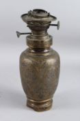 A BRADLEY HUBBARD 1870'S ENGRAVED BRASS OIL LAMP. 32cms high.